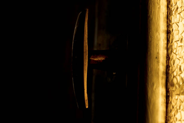 istock An old Handle and a yellow glass. Dark light view. 1224495880