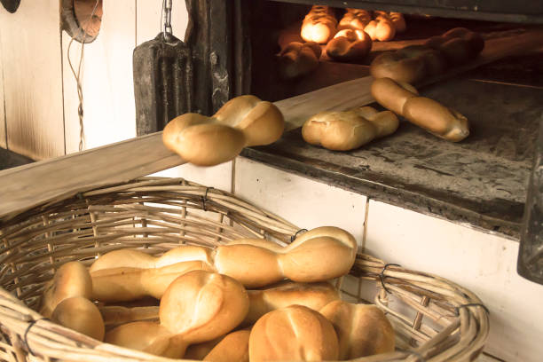 Fresh Chilean rustic marraqueta breads in a bakery factory. Fresh Bread hand made close up. Bakery, food concept. Artisanal bakery: Fresh mixed Bun, rolls and ingredients. Bread production in bakery factory.