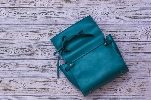 istock Unbuttoned women's leather bag on a wooden background. 1224497005
