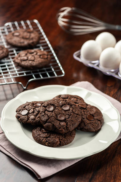 istock Chocolate Cookies on a plate with recipe ingredients on background 1224497101