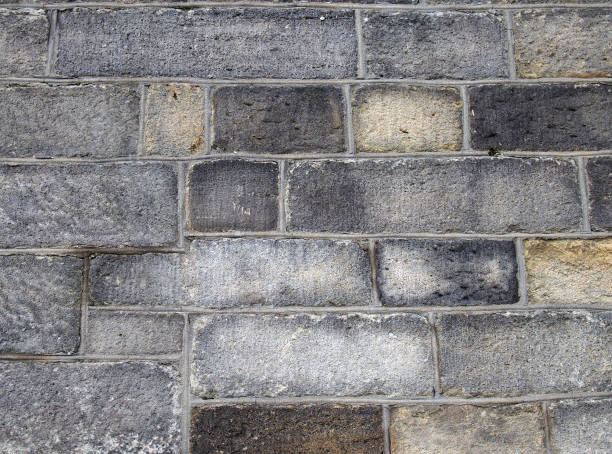 istock a full frame image of a large old dark stone wall made of large irregular sandstone blocks 1224498801