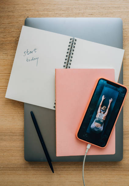 istock Motivational Mondays: a Mobile Phone, a Notebook and a Laptop on a Woman's Desk 1224502232