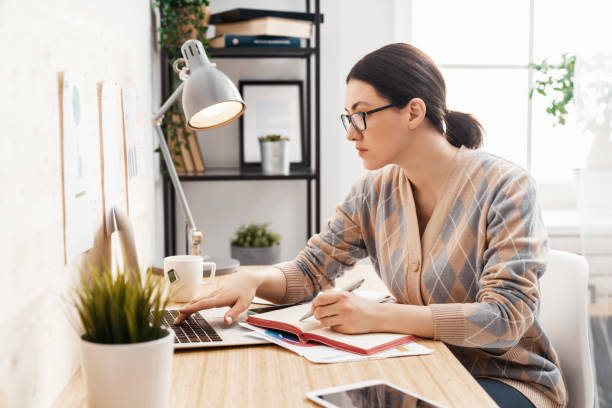 istock woman working on a laptop at home. 1224505528