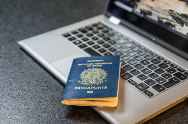 istock Brazilian passport and computer. 1224506430