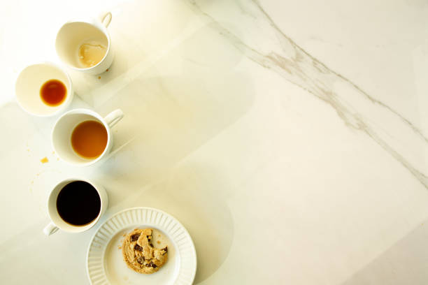 istock lot of cups of coffees on white marble table, hard work concept 1224506614