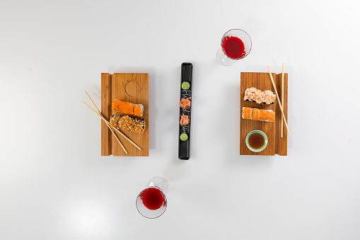 Set of sushi and rolls with salmon and tuna, avocado, california, maki, soy sauce, chopsticks close-up.