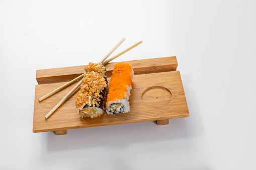 Set of sushi and rolls with salmon and tuna, avocado, california, maki, soy sauce, chopsticks close-up.