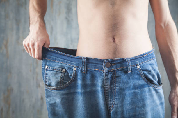 istock Man wearing big size jeans. Weight loss 1224511754