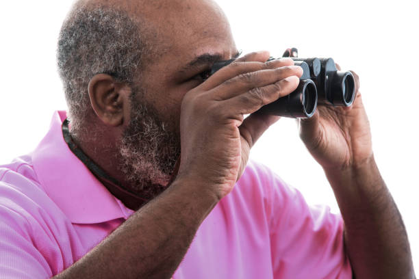 istock African American man looking through binoculars on white background 1224512334