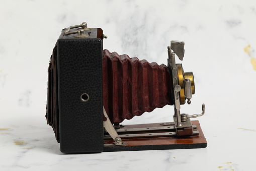 Beautiful turn-of-the-century wooden view camera with red bellows. Vinatge photography