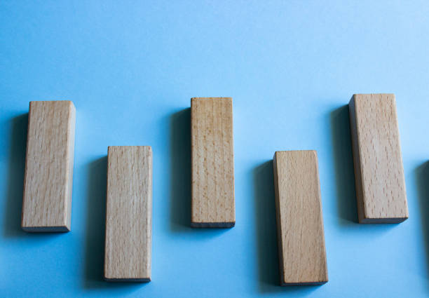 istock Set of five wooden blocks in different angles, isolated on a blue background. 1224513723
