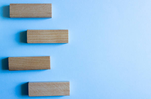 istock Set of four wooden blocks in different angles, isolated on a blue background. 1224513724