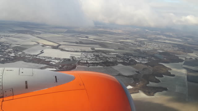 The plane flies under the clouds over the snowy fields of Ukraine - view from the window (16)