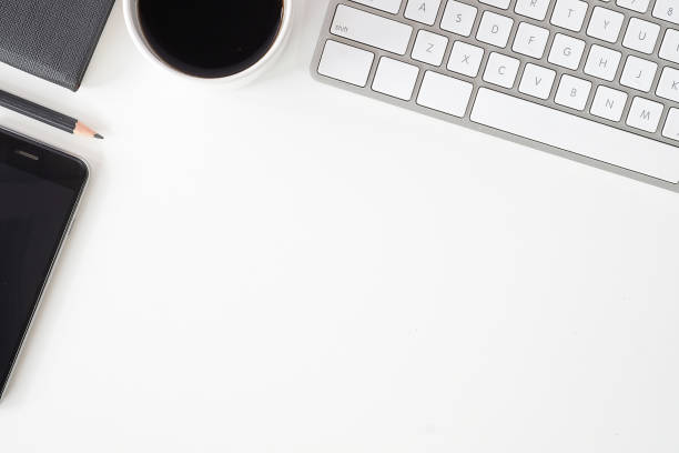 istock Top view office stuff with notepad, laptop and coffee cup mouse notepad shot.blank screen mobile phone and supplies on white desk workspace and copy space. 1224515340