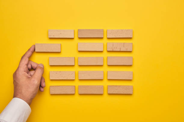 istock Men's hand and wooden blocks arranged in a conceptual image 1224516505