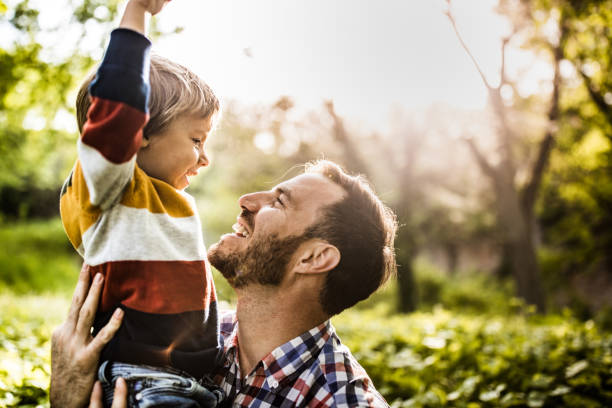 istock Happy single father and son having fun while talking in nature. 1224516681