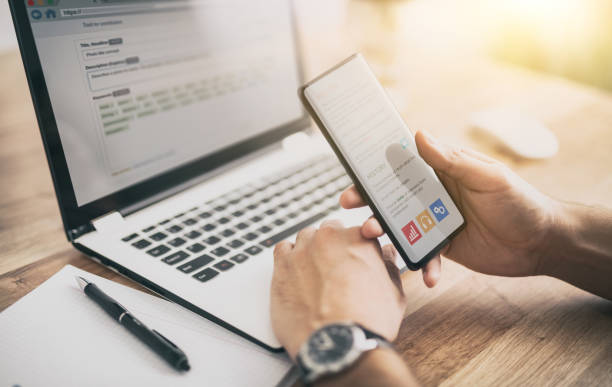 istock Man works at home and uses a smart phone and notebook computer. 1224518740