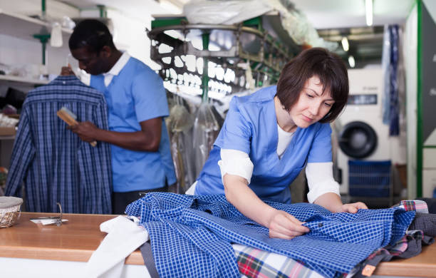 istock Woman worker checking clean clothes 1224519595
