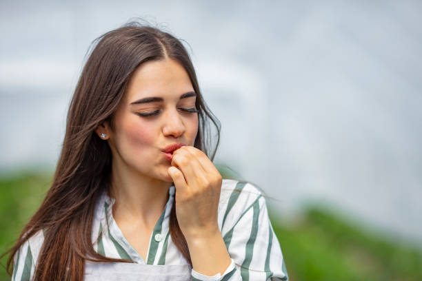 istock Pretty brunette eating strawberries 1224521182