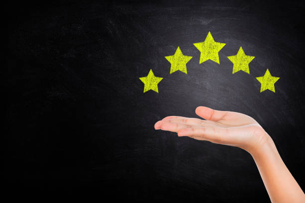 istock Hand showing and giving best service ranking with five stars on chalkboard. 1224522030