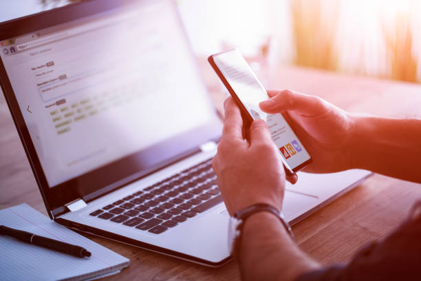 istock Man works at home and uses a smart phone and notebook computer. 1224524543