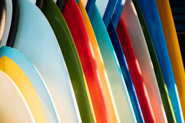 istock Close up Set of different color surf boards in a stack on sandy beach for rent. Multicolored surfboards as rainbow. 1224524761