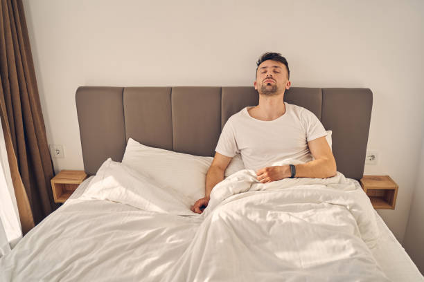 istock Tired brunette man trying to sleep in his bed 1224527148