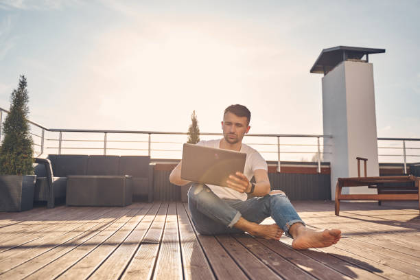 istock Stylish brunette man spending time with his electronic device 1224527170