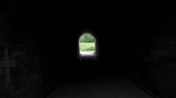 istock dark tunnel with light at the end 1224528994