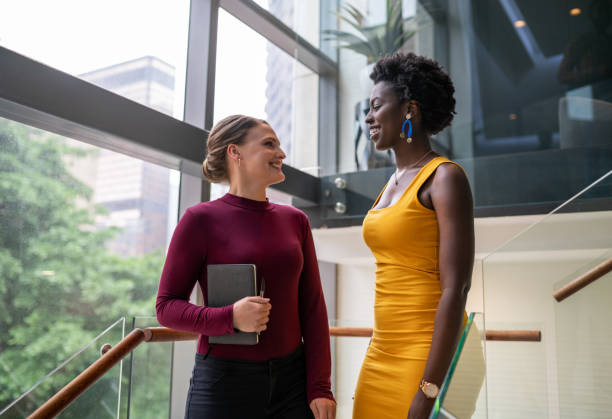 istock Two smiling young businesswomen talking on some office stairs 1224531609