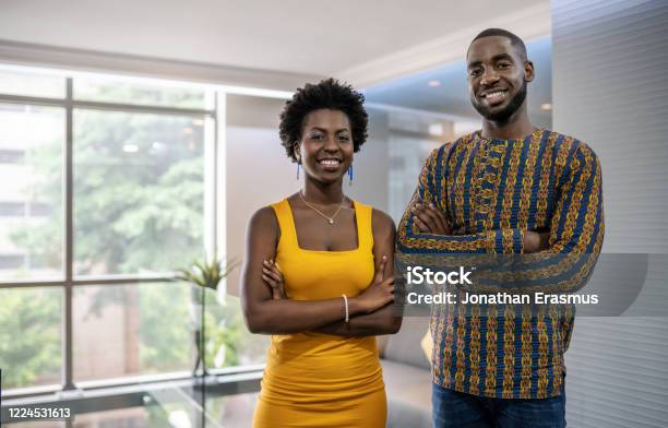 Two Confident Young African Businesspeople Standing In A Modern Stock Photo - Download Image Now