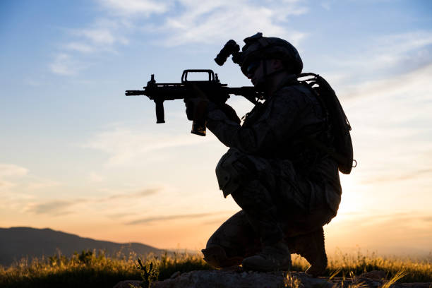 istock Silhouette of an aiming soldier against sunset 1224533404