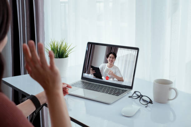 istock Asian friend video conference user interface on laptop computer online remotely working from home social distancing discuss business with internet video call technology when quarantine self isolation. 1224533618
