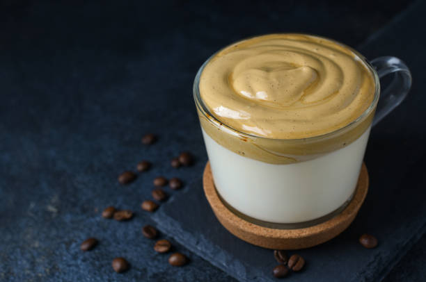 istock Dalgona coffee in glass cup with coffee beans on dark background. 1224534694