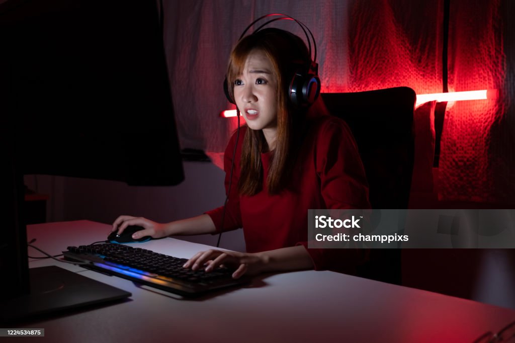 Pro Player Gamer Young Asian Woman Playing Online Video Game Shooting Fps  Tournament Ranking Cyber Internet At Night Red Neon Light Room With Gaming  Headset And Keyboard On Championship Event Stock Photo 