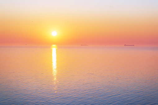 Sunrise over the calm sea, minimalistic landscape