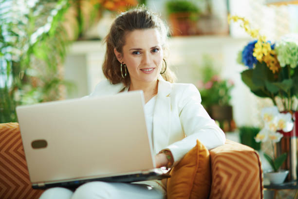 istock female in modern living room in sunny day using website 1224536497