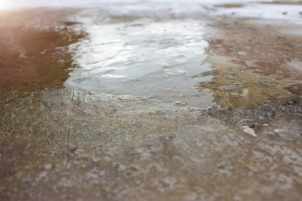 istock Ice on the road close up. Slippery ice-crusted ground surface. 1224536709