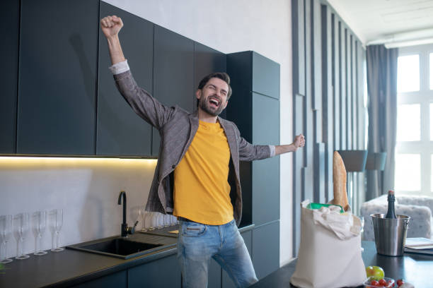 istock Cheerful man with closed eyes rejoicing in the kitchen. 1224537539