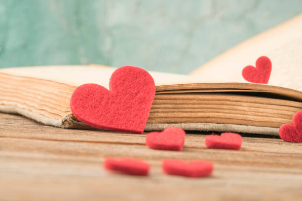 istock Opened book on table decorated with hearts 1224538612