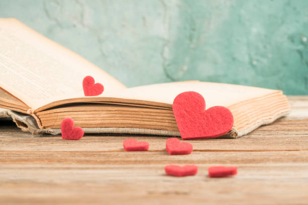 istock Opened book on table decorated with hearts 1224538622