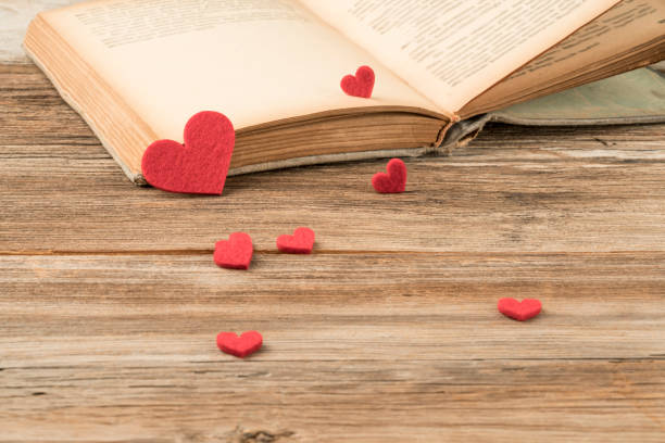 istock Opened book on table decorated with hearts 1224538623