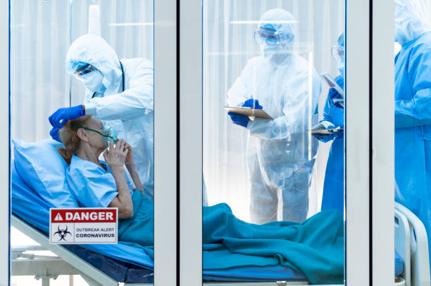istock coronavirus covid 19 disease doctor put air ventilator for infested coronavirus covid 19 patient with a team monitoring the symptom in clean quarantine room with danger outbreak alert sign 1224538706