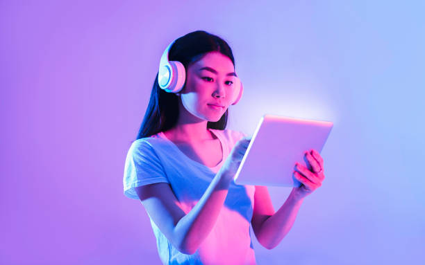 istock Woman working on tablet with wireless headphones 1224539842