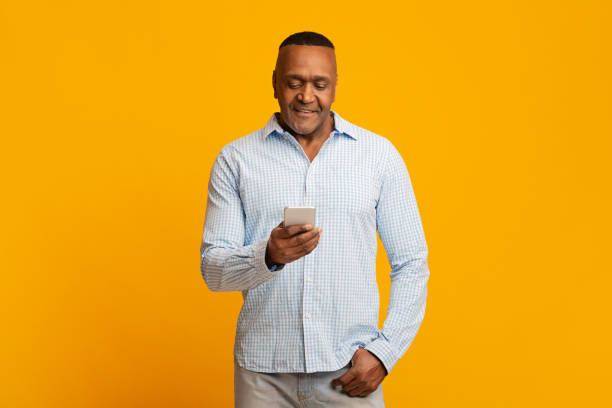 istock Modern mature african man chatting on cellphone 1224540047