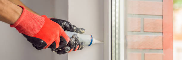 istock Man in a blue shirt does window installation BANNER, LONG FORMAT 1224541162
