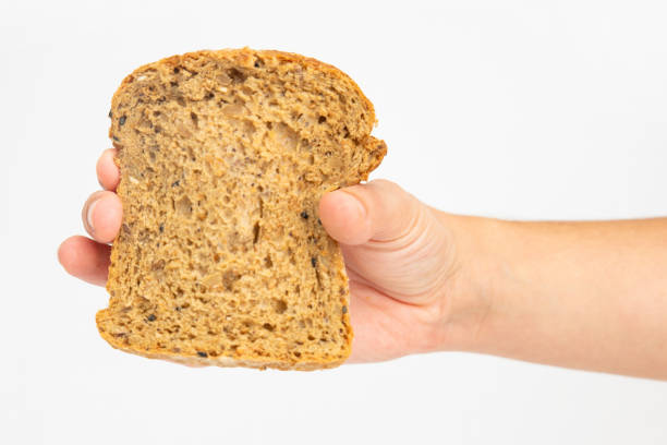 istock One slice of cereal loaf in female hand 1224542972