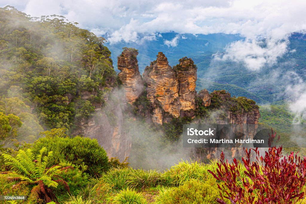 Three Sisters Rock Formation in Blue Mountains in New South Wales, Australia The Three Sisters are an unusual rock formation in the Blue Mountains of New South Wales, Australia, on the north escarpment of the Jamison Valley. They are located close to the town of Katoomba and are one of the Blue Mountains' best known sites, towering above the Jamison Valley. Blue Mountains - Australia Stock Photo