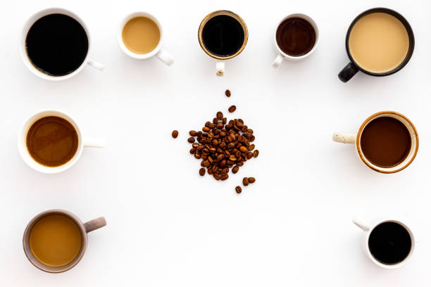 istock Cups of hot drinks on white desk top view 1224544081