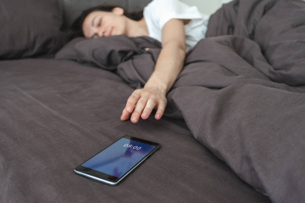 istock Woman waking up and switch off notification on smartphone 1224546923